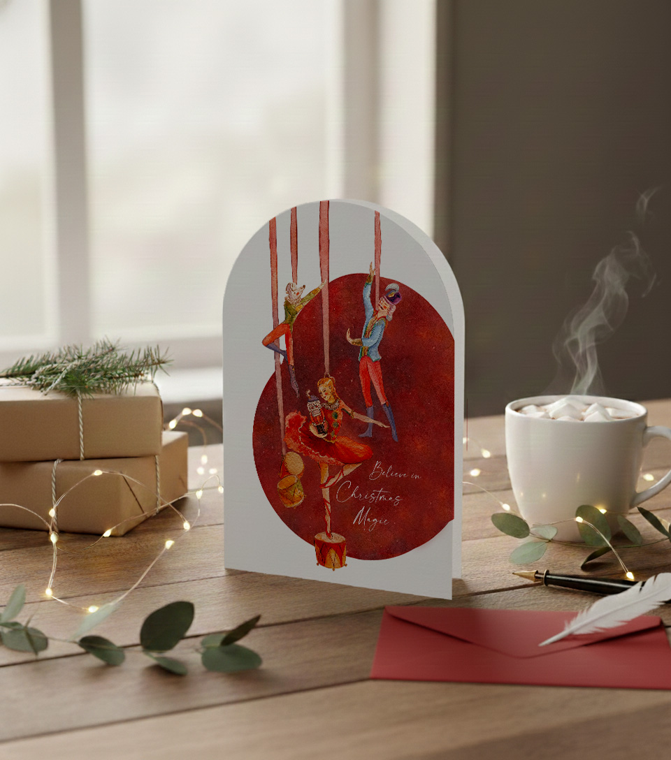 Romantic illustrated Christmas card with nutcracker ballet figures and the words “Believe in Christmas Magic”