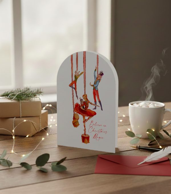 Romantic illustrated Christmas card with nutcracker ballet figures and the words “Believe in Christmas Magic”